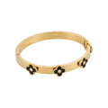 Gold-plated hinged black clover charm bangle on white - Avenzra Black Clover Gold Bangle