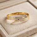 Gold crossover cuff bangle with three rows of stones in jewellery box - Avenzra Gold Crossover Stone Bangle
