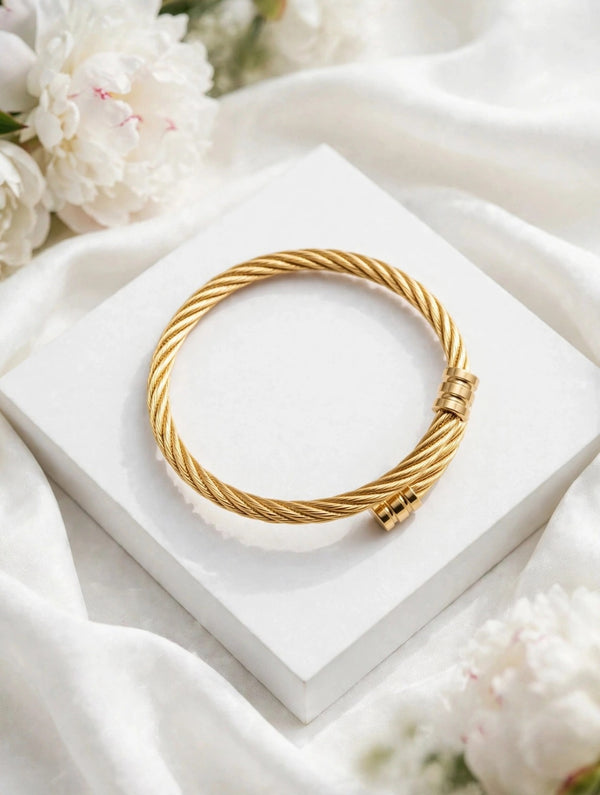 Golden twisted cable cuff bangle on white box - Avenzra Golden Unisex Cuff Bangle for Men & Women