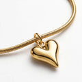 Close-up of gold heart charm on snake chain bracelet - Avenzra Heart Charm Bracelet
