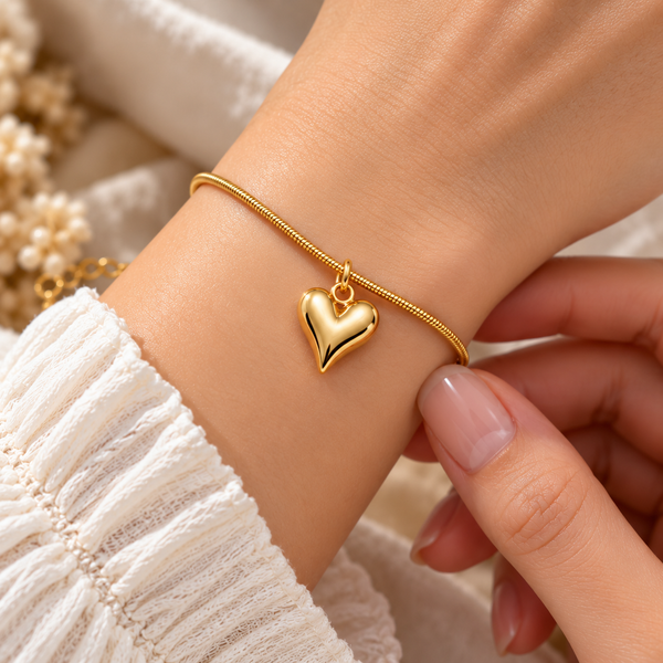 Golden snake chain bracelet with puffy heart charm on wrist - Avenzra Heart Charm Bracelet