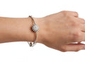 Silver starburst flower bangle worn on wrist - Avenzra Starburst Bangle & Ring Set