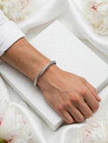 Silver twisted cable cuff bangle worn on wrist - Avenzra Twisted Cable Bangle