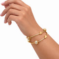 Wrist wearing two stacked gold charm bangles - Avenzra Gold Charm Bangle