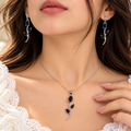 Model wearing silver and black stone tulip necklace and drop earrings - Avenzra Tulip Jewellery Set